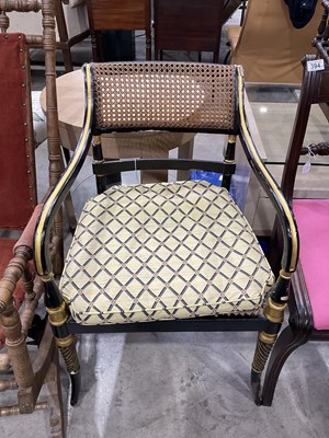 Lot 395 - A Regency ebonised and gilt armchair with cane...