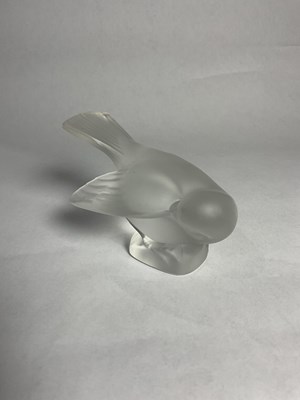 Lot 138 - A Lalique frosted sparrow head in wing...