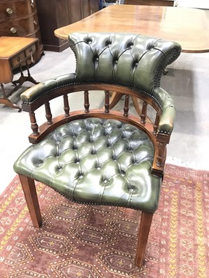 Lot 402 - A green leather captains desk chair with...