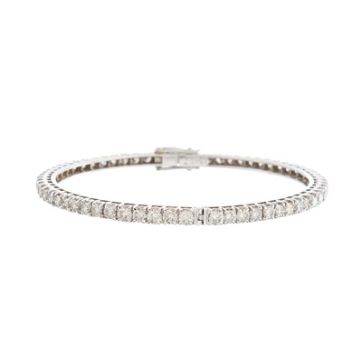 Lot 156 - A brilliant-cut diamond line bangle bracelet,...