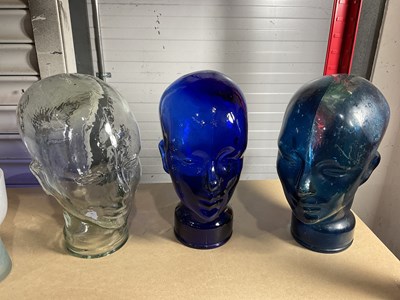 Lot 139 - Three 20th century moulded glass display heads,...