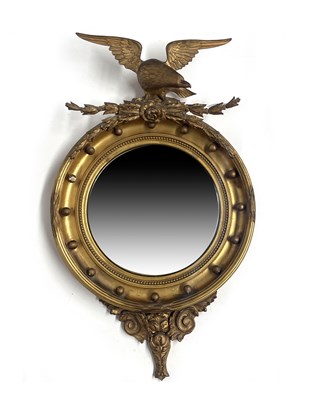 Lot 230 - A carved gilt wood convex looking glass, 19th...