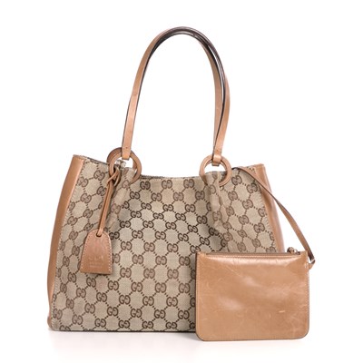 Lot 311 - Gucci, a monogram handbag with pouch, crafted...