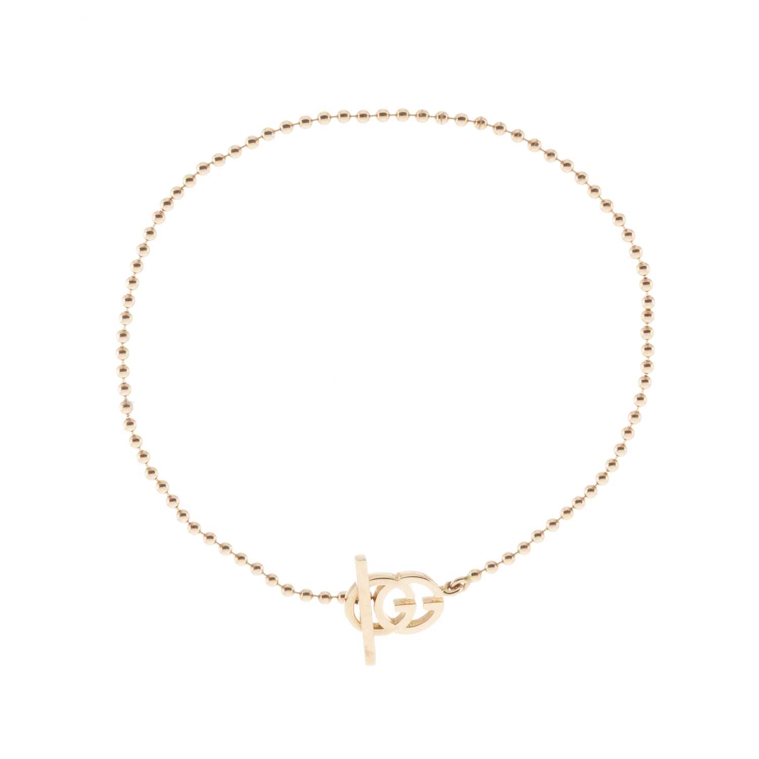 Lot 112 - Gucci, an 18ct gold Running G toggle bracelet