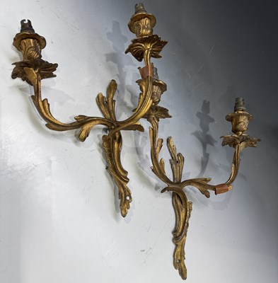 Lot 194 - A pair of twin branch gilt metal wall sconces,...