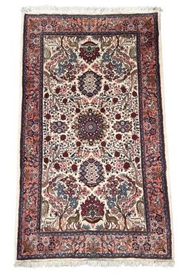 Lot 504 - Modern Iranian rug, the ivory field with birds...