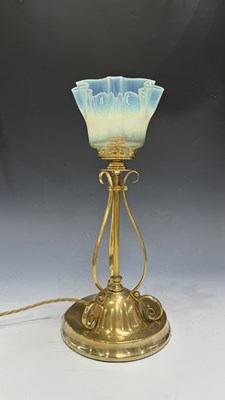 Lot 545 - An Edwardian Arts & Crafts brass table lamp,...