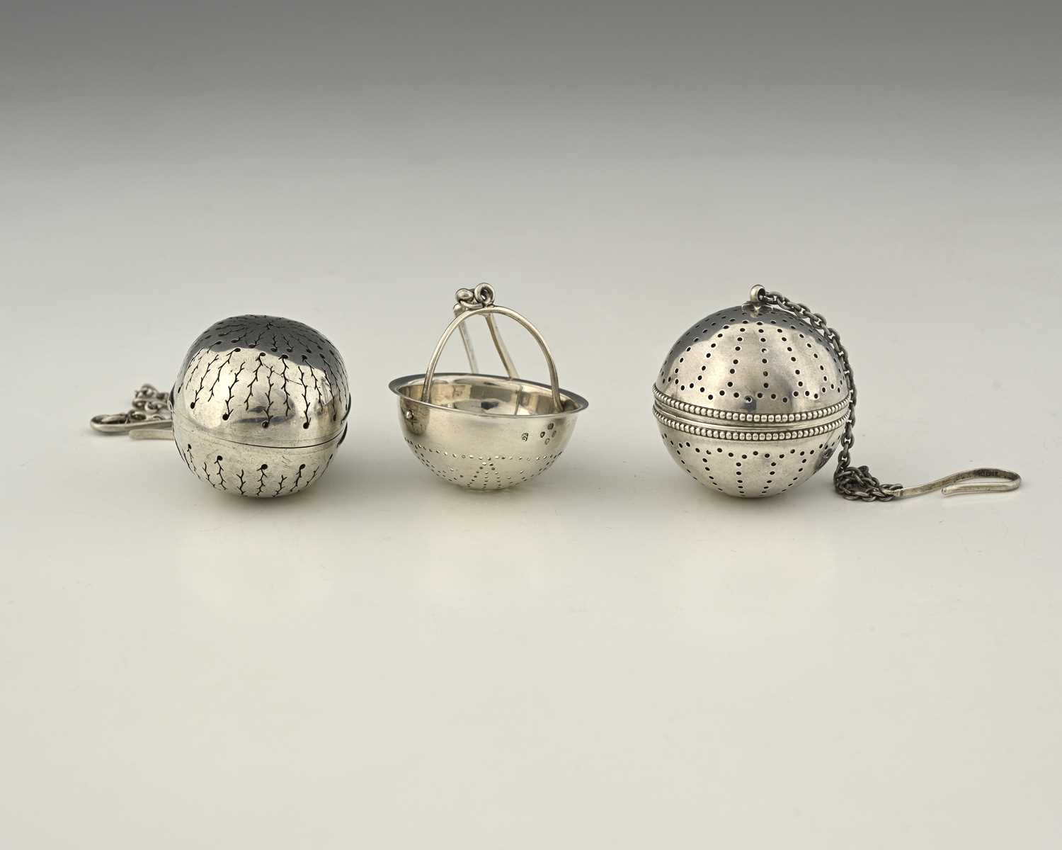 Lot 148 - A Victorian silver tea infuser, the pierced