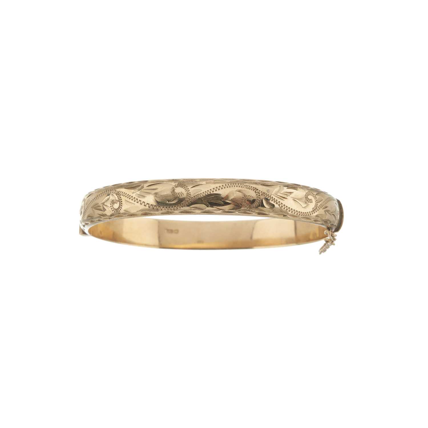 Lot 20 - A 9ct gold engraved bangle bracelet