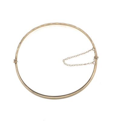 Lot 20 - A 9ct gold engraved bangle bracelet