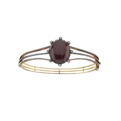 Lot 15 - A late Victorian gold garnet and diamond bangle bracelet