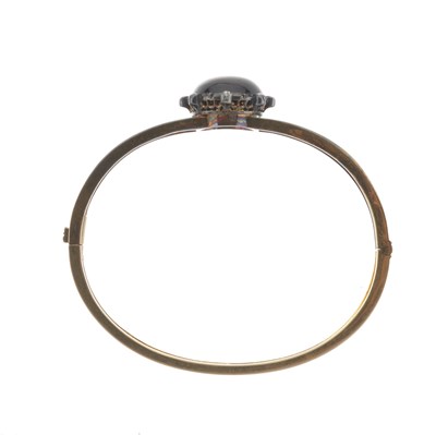 Lot 15 - A late Victorian gold garnet and diamond bangle bracelet