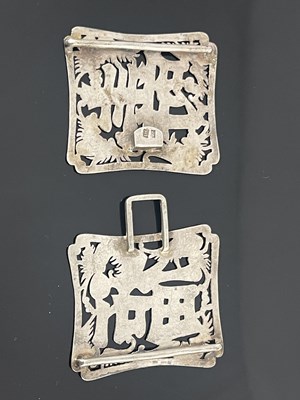 Lot 83 - A Chinese silver buckle, each shaped...