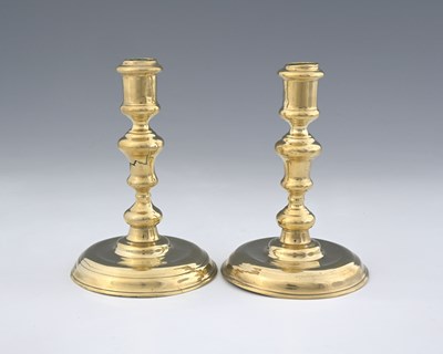 Lot 169 - A pair of George I brass candlesticks, circa...