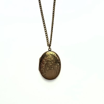 Lot 433 - A 9ct gold back and front locket pendant, with yellow metal chain