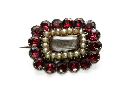 Lot 438 - A late Georgian yellow metal garnet and spilt pearl mourning brooch