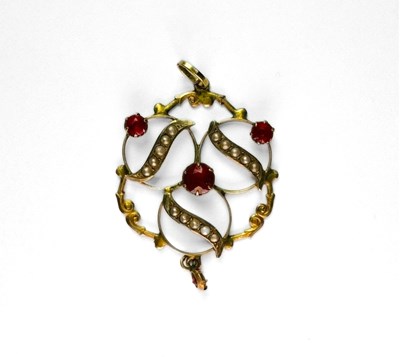 Lot 437 - An early 20th century yellow metal, red paste and split pearl pendant