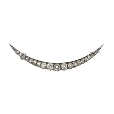 Lot 27 - A late 19th century silver and gold diamond crescent brooch