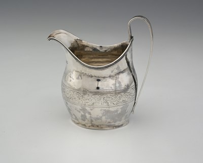 Lot 314 - A George III silver helmet-shaped cream jug,...