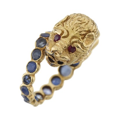 Lot 72 - Zolotas (attr.), an 18ct gold sapphire, ruby and diamond lion's head bypass ring