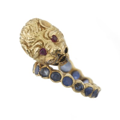 Lot 72 - Zolotas (attr.), an 18ct gold sapphire, ruby and diamond lion's head bypass ring