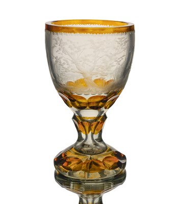 Lot 405 - A Bohemian amber cased engraved glass goblet,...