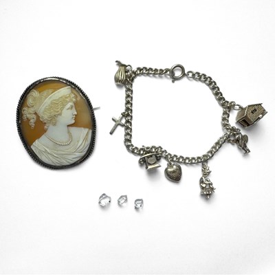 Lot 427 - A silver charm bracelet, a shell cameo brooch and three loose quartz crystals