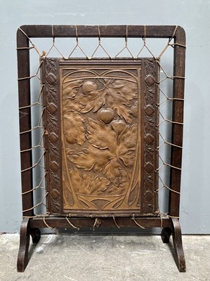Lot 565 - An Arts & Crafts firescreen, stretched leather...