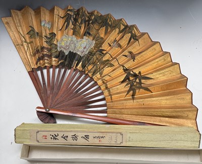 Lot 255 - A large Chinese fan, gilt paper painted with...