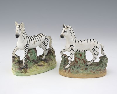 Lot 595 - Two Staffordshire Zebra figures, each modelled...