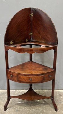 Lot 566 - A Georgian mahogany corner washstand, hinged...