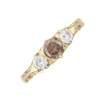Lot 156 - An 18ct gold brown diamond and diamond three-stone ring