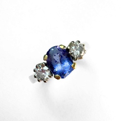 Lot 408 - An 18ct gold tanzanite and diamond three-stone ring