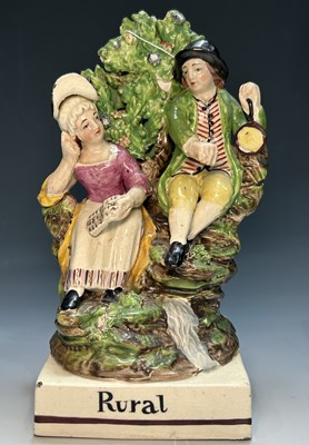 Lot 115 - A Staffordshire pottery pearlware figure group,...