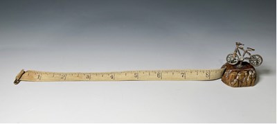 Lot 379 - A novelty brass tape measure, in the form of a...