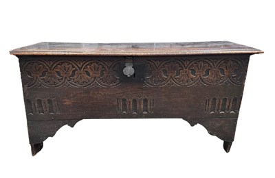 Lot 557 - A small carved oak plank chest, probably...