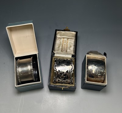 Lot 218 - Three boxed silver napkin rings, including an...