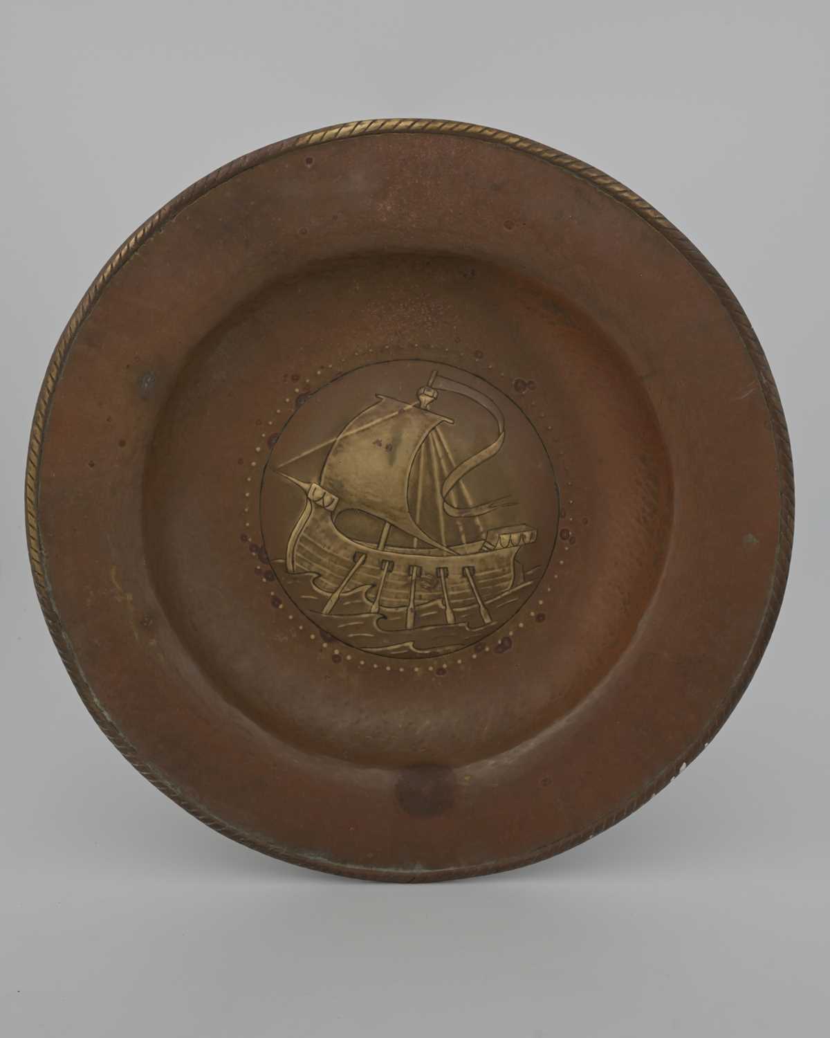 Lot 95 - An Arts and Crafts brass charger, repousse...