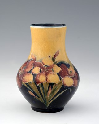 Lot 530 - William Moorcroft, a Freesia on ochre vase,...