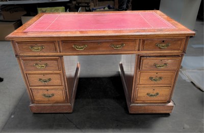 Lot 615 - A twin pedestal kneehole desk, banks of three...