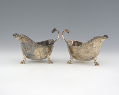 Lot 299 - A pair of George V silver sauce boats, each...