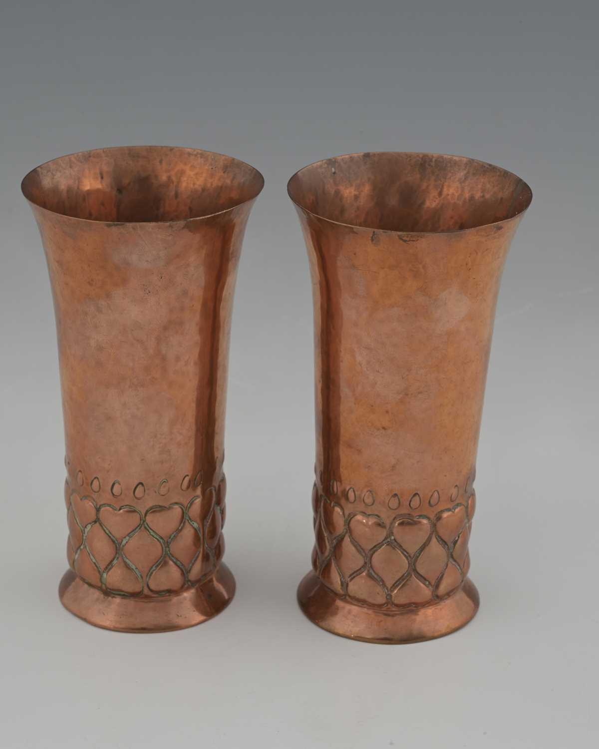 Lot 91 - A pair of Arts and Crafts copper vases, in the...