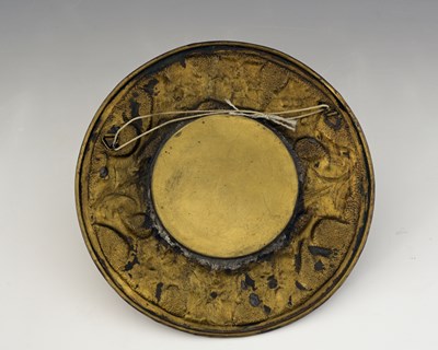 Lot 101 - An Arts and Crafts brass mirror, circular form,...
