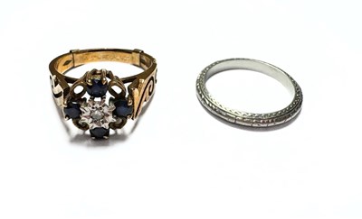 Lot 414 - A 9ct gold sapphire and diamond ring, and a platinum wedding band ring