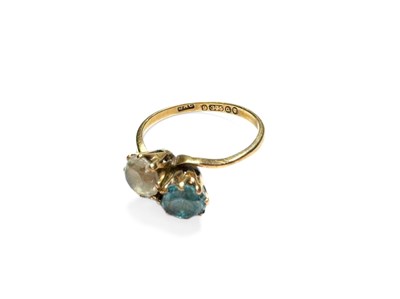 Lot 423 - A 9ct gold blue and white zircon crossover ring