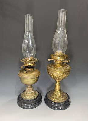 Lot 630 - Two Victorian brass oil lamps with glass...