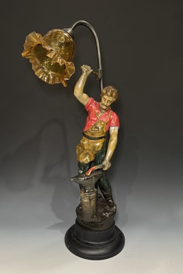 Lot 645 - A figural painted cast metal table lamp in the...