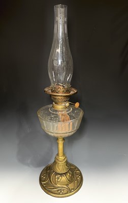 Lot 672 - An Arts & Crafts brass oil lamp with glass...