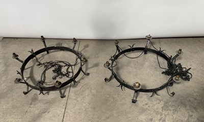 Lot 598 - Two black painted wrought iron wheel-type...