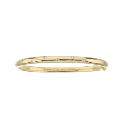 Lot 105 - Tiffany & Co., an 18ct gold and platinum, diamond Etoile bangle bracelet